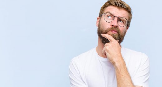 young blonde adult man thinking, feeling doubtful and confused, with different options, wondering which decision to make